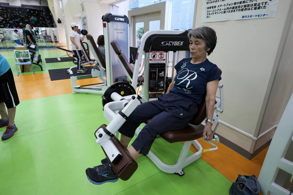 Yasuko Kuroi, 72, uses a leg extension machine as she works out at the Fukagawa Sports Center i ...