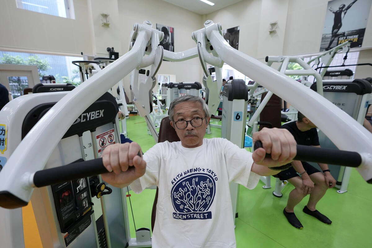Toshiyuki Honma, 70, uses a chest press machine as he works out at the Fukagawa Sports Center i ...