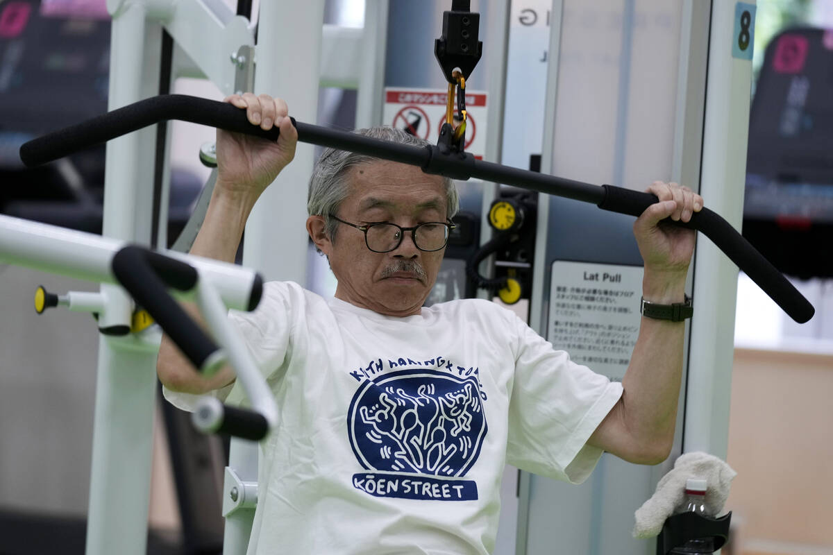 Toshiyuki Honma, 70, uses a lat pulldown machine as he works out at the Fukagawa Sports Center ...