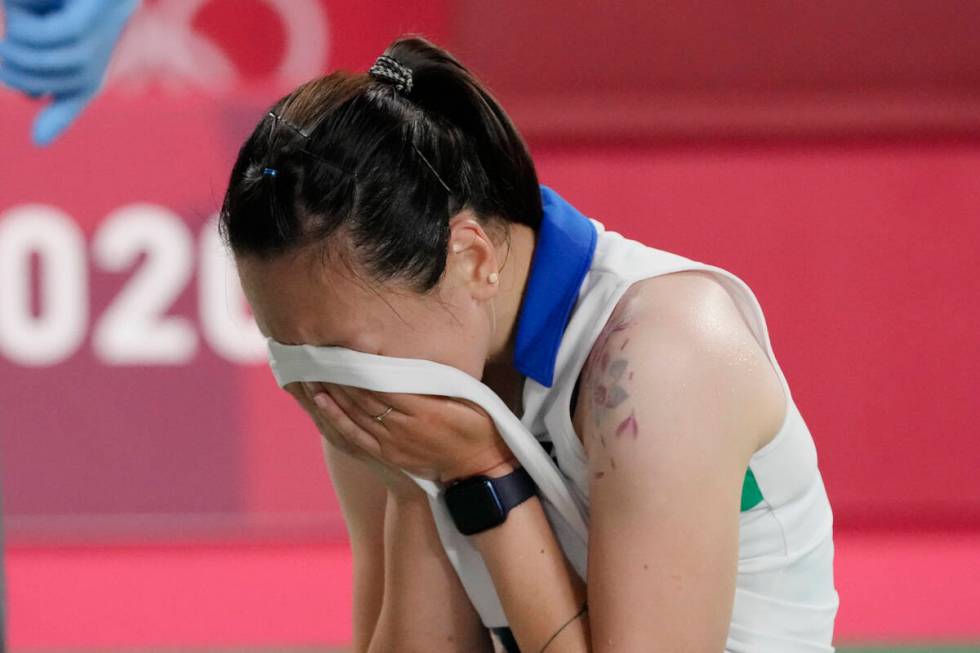 Beiwen Zhang, of the United States, cries after being injured and not being able to complete he ...