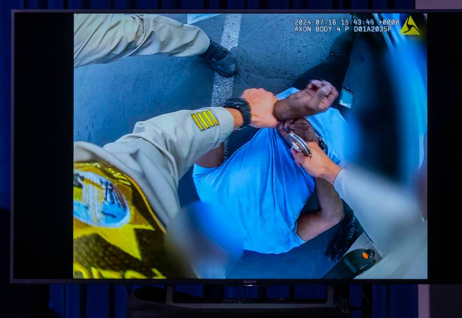 Body worn camera video of a Metro officer arresting a subject is shown during a news conference ...