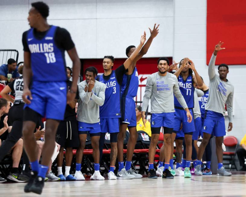 The Dallas Mavericks bench celebrates after forward Olivier-Maxence Prosper (18) scored a three ...