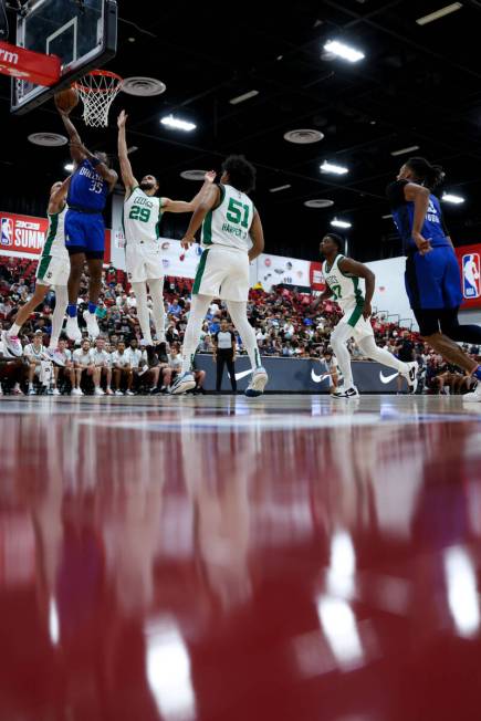 Dallas Mavericks guard TJ Clark (28) shoots Boston Celtics forward Tristan Enaruna (29) during ...