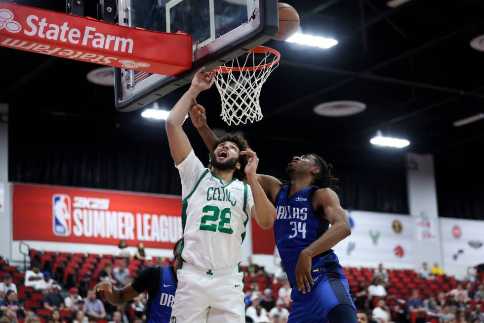 Dallas Mavericks forward Isaiah Whaley (34) thwarts a shot by Boston Celtics forward Anton Wats ...