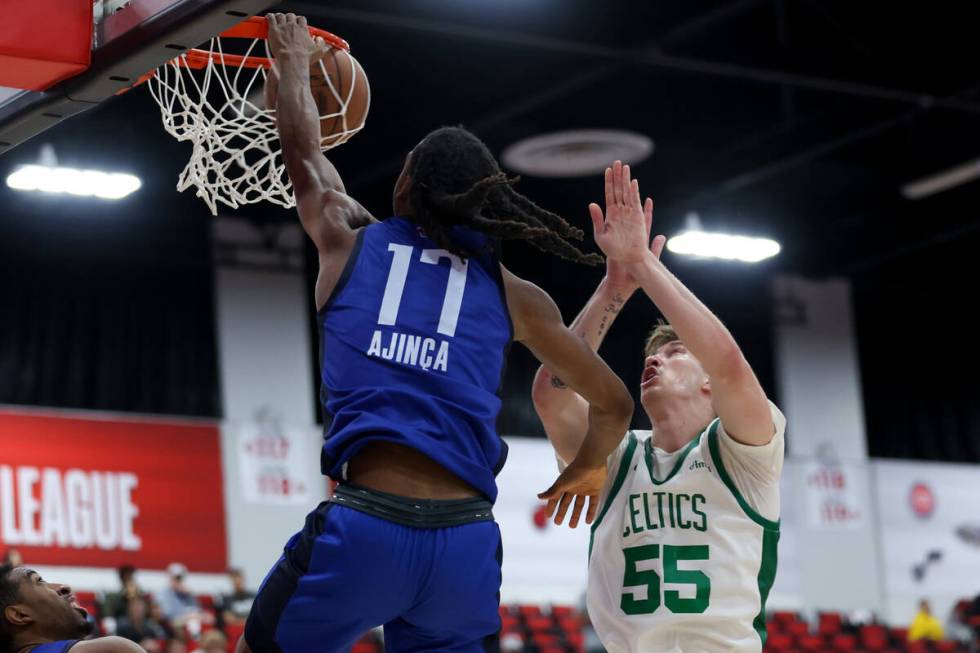 Dallas Mavericks forward Melvin Ajinca (17) dunks the ball over Boston Celtics guard Baylor Sch ...