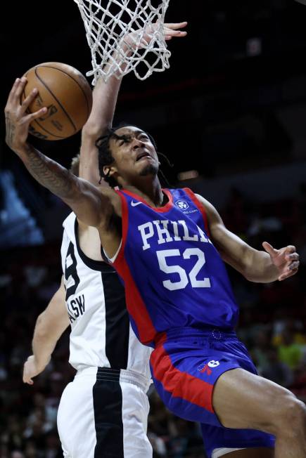 Philadelphia 76ers guard Judah Mintz (52) shoos against San Antonio Spurs forward Yauhen Massal ...