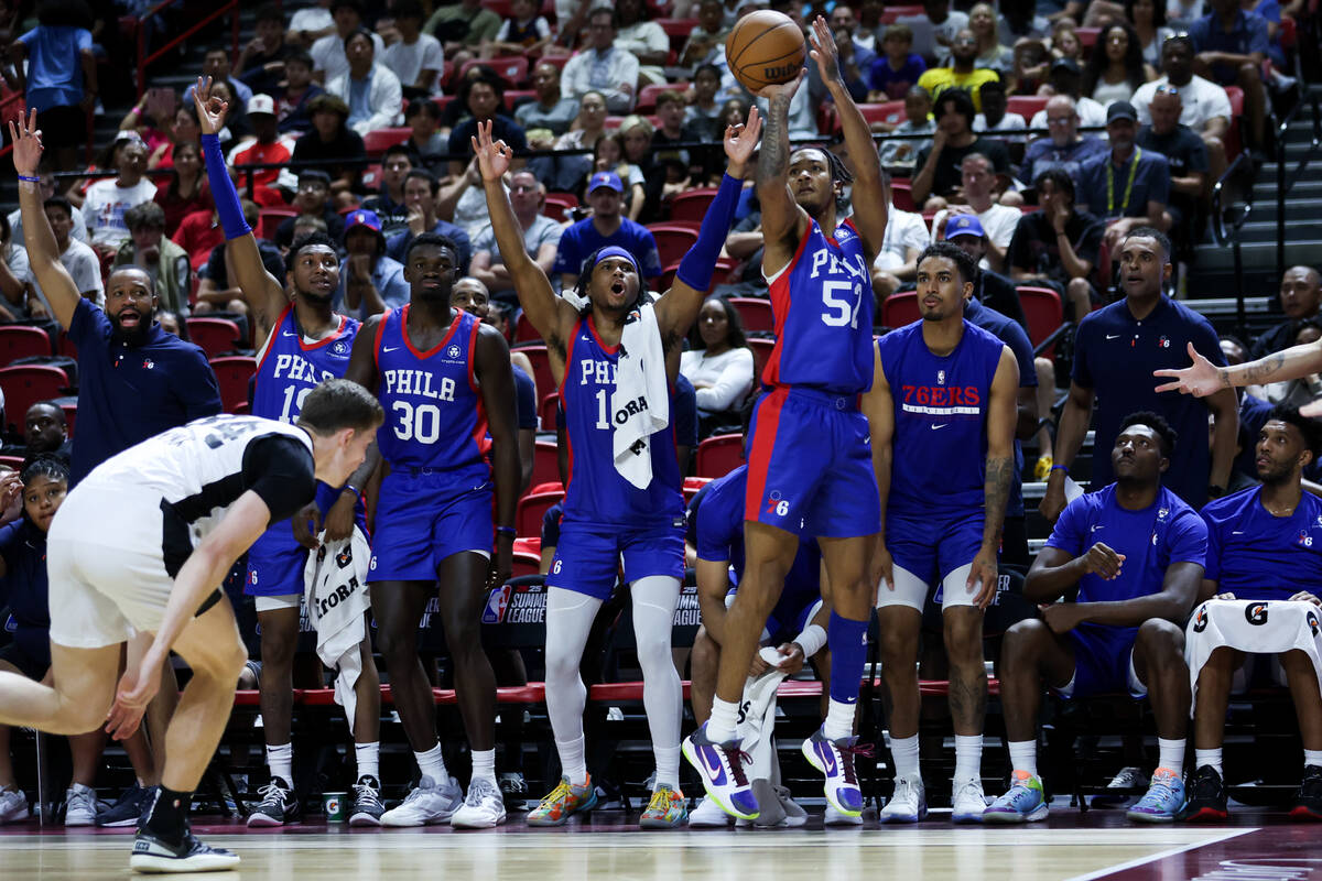 The Philadelphia 76ers bench goes wild as guard Judah Mintz (52) shoots a three-point basket du ...