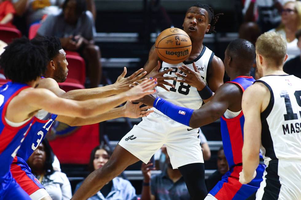 San Antonio Spurs guard DJ Horne (18) struggles for a rebound with pressure from the Philadelph ...