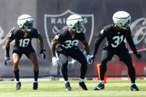 Raiders cornerbacks Jack Jones (18) Nate Hobbs (39) and Brandon Facyson (31) run through drills ...