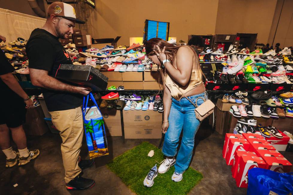 An attendee tries on a pair of Nike Jordan shoes during Sneaker Con at the Mandalay Bay Convent ...