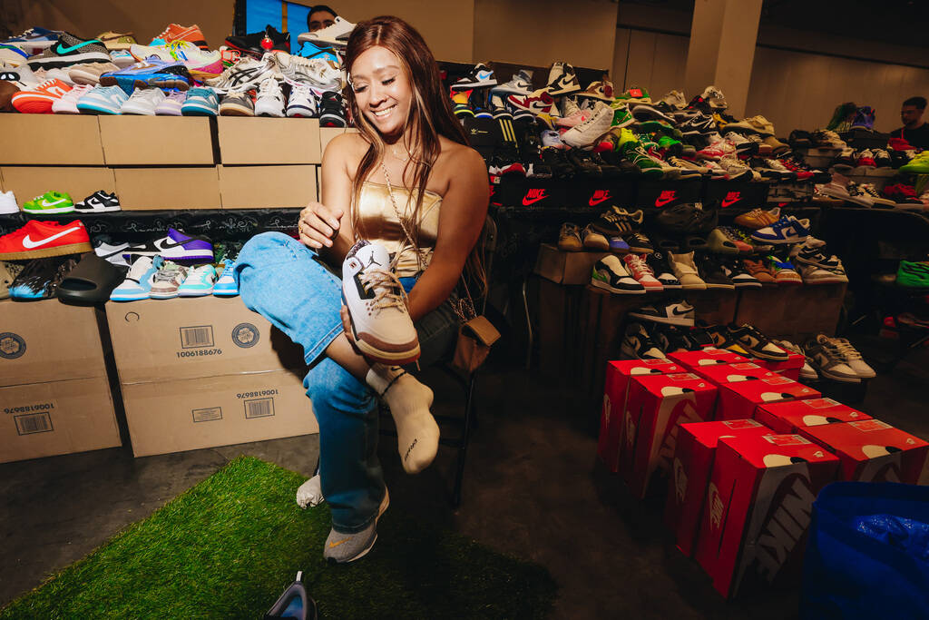 An attendee tries on a pair of Nike Jordan shoes during Sneaker Con at the Mandalay Bay Convent ...