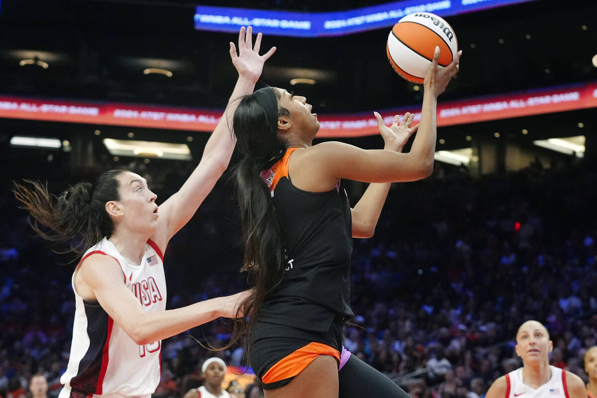 CORRECTS TO REESE NOT REECE - Angel Reese, front right, of Team WNBA, drives past Breanna Stewa ...