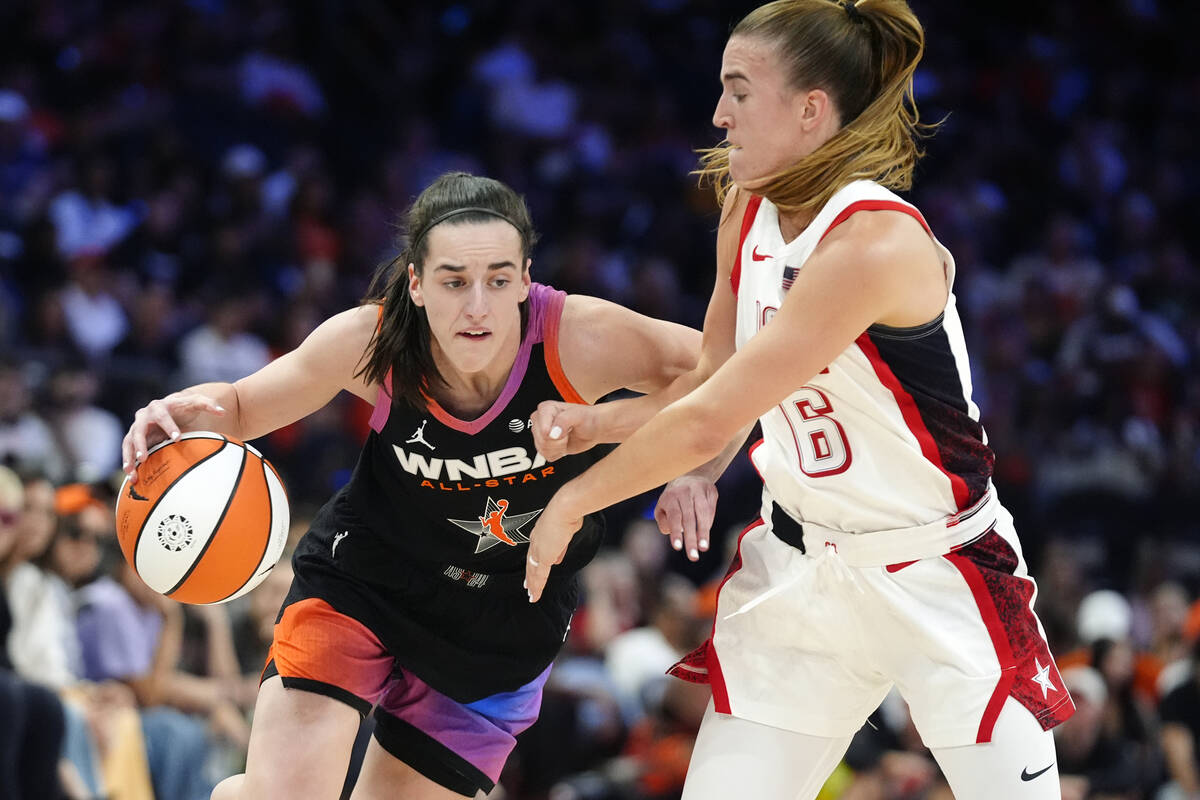 Caitlin Clark, left, of Team WNBA, dribbles against Sabrina Ionescu (6), of Team USA, during th ...