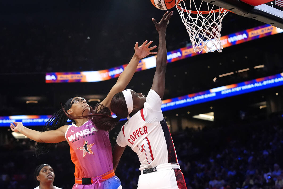 Kahleah Copper, right, of Team USA, drives past Allisha Gray, front left, of Team WNBA, to scor ...