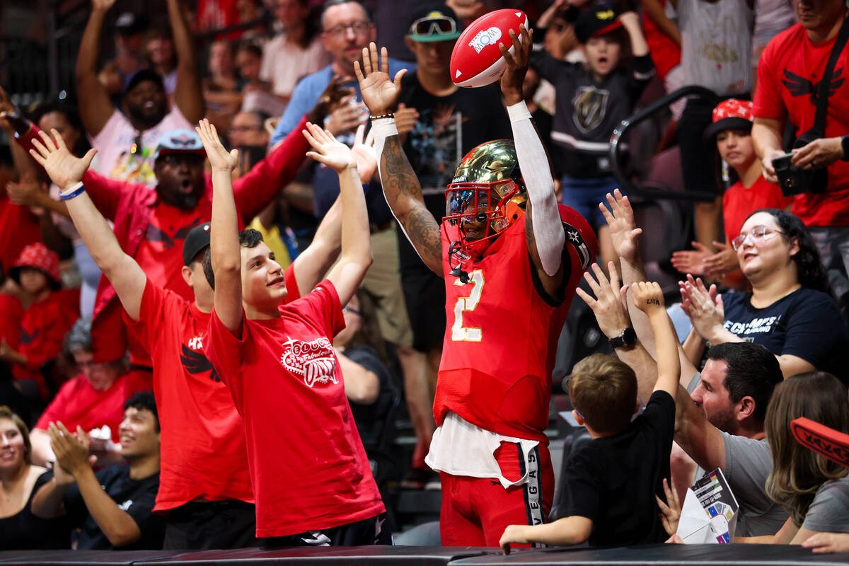 Vegas Knight Hawks quarterback Ja'Rome Johnson (2) celebrates in the stands with fans after sco ...