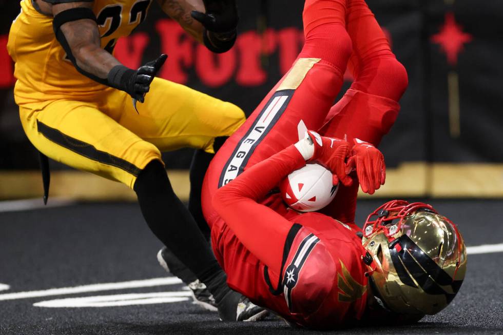 Vegas Knight Hawks wide receiver Quentin Randolph (4) tumbles while catching a pass while Tusco ...