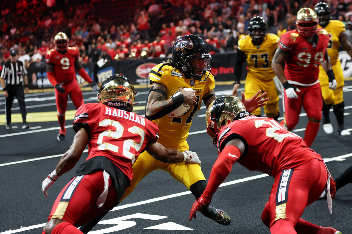 Tucson Sugar Skulls quarterback Vincent Espinoza (11) works toward the end zone while Vegas Kni ...