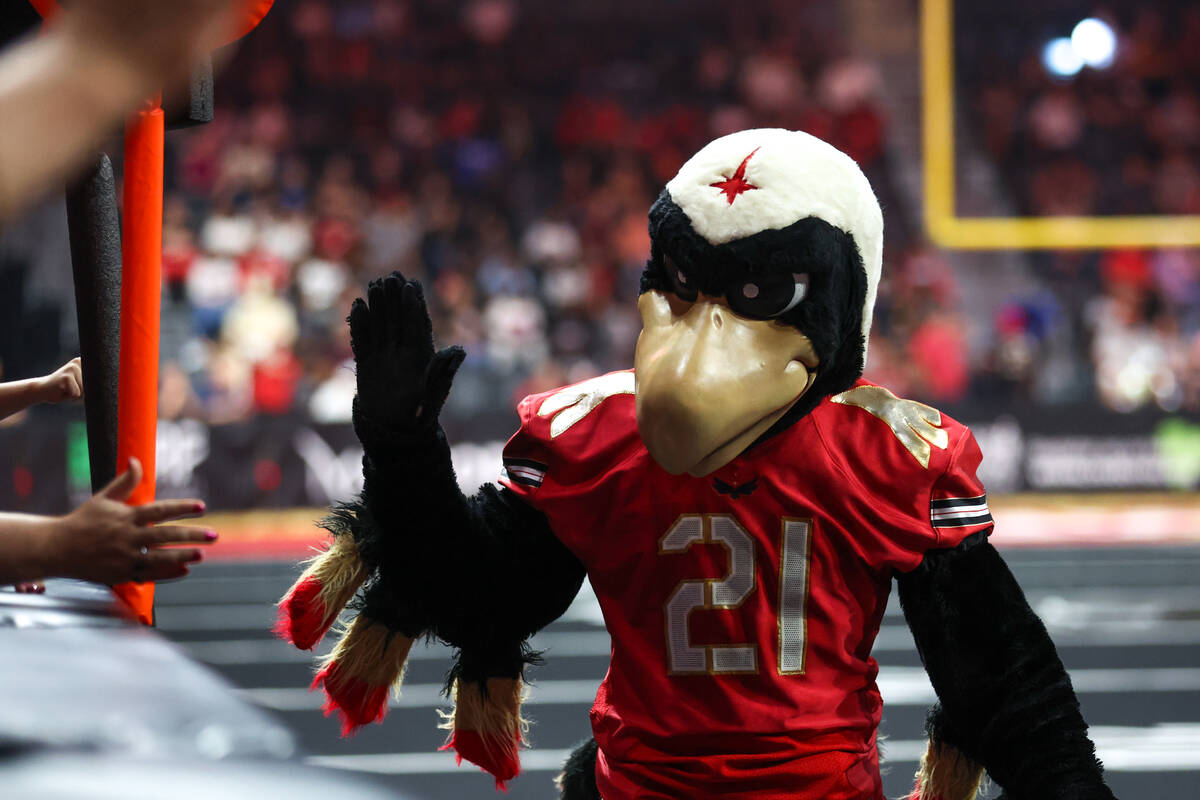 The Vegas Knight Hawks mascot, Risk, high-fives fans during an IFL (Indoor Football League) gam ...