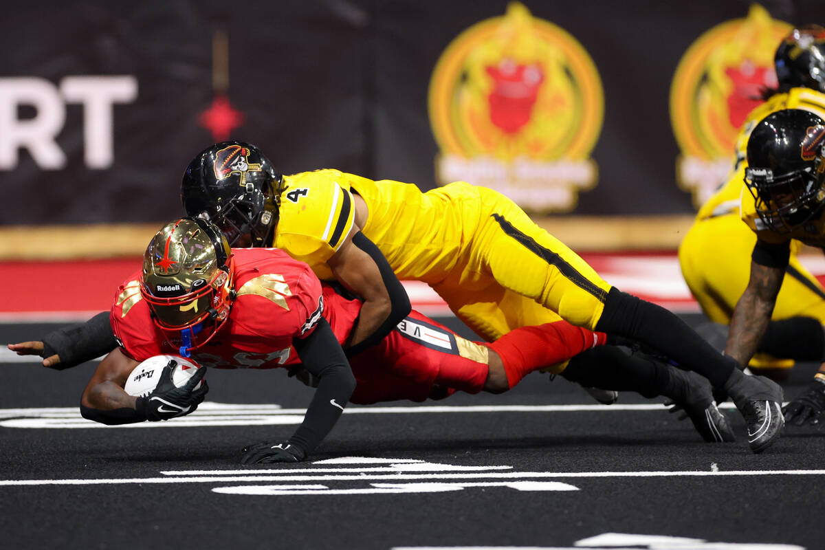 Vegas Knight Hawks wide receiver Marquis Lawson (4) dives with the ball while Tucson Sugar Skul ...