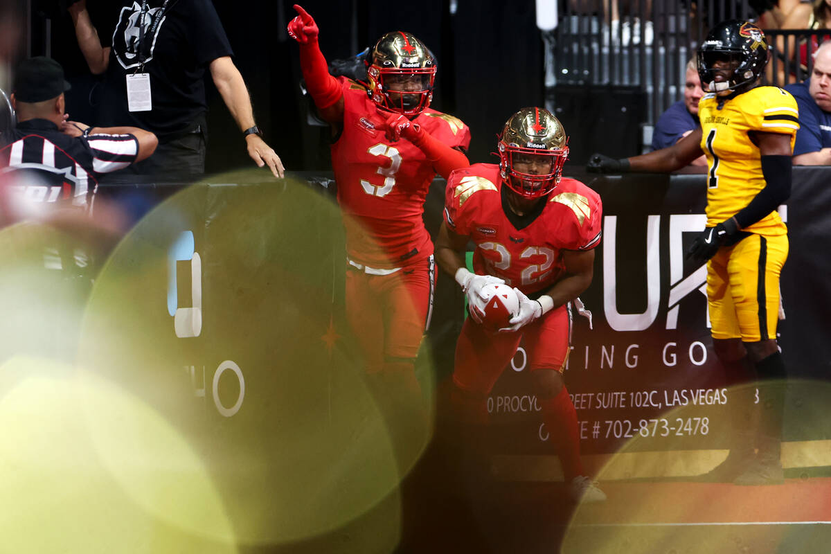 Vegas Knight Hawks defensive backs JaQuan Amos (3) and Malik Hausman (22) react after thwarting ...