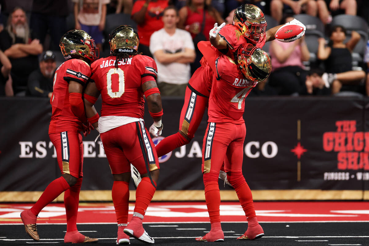 Vegas Knight Hawks wide receiver Quentin Randolph (4) lifts up defensive back Malik Hausman aft ...