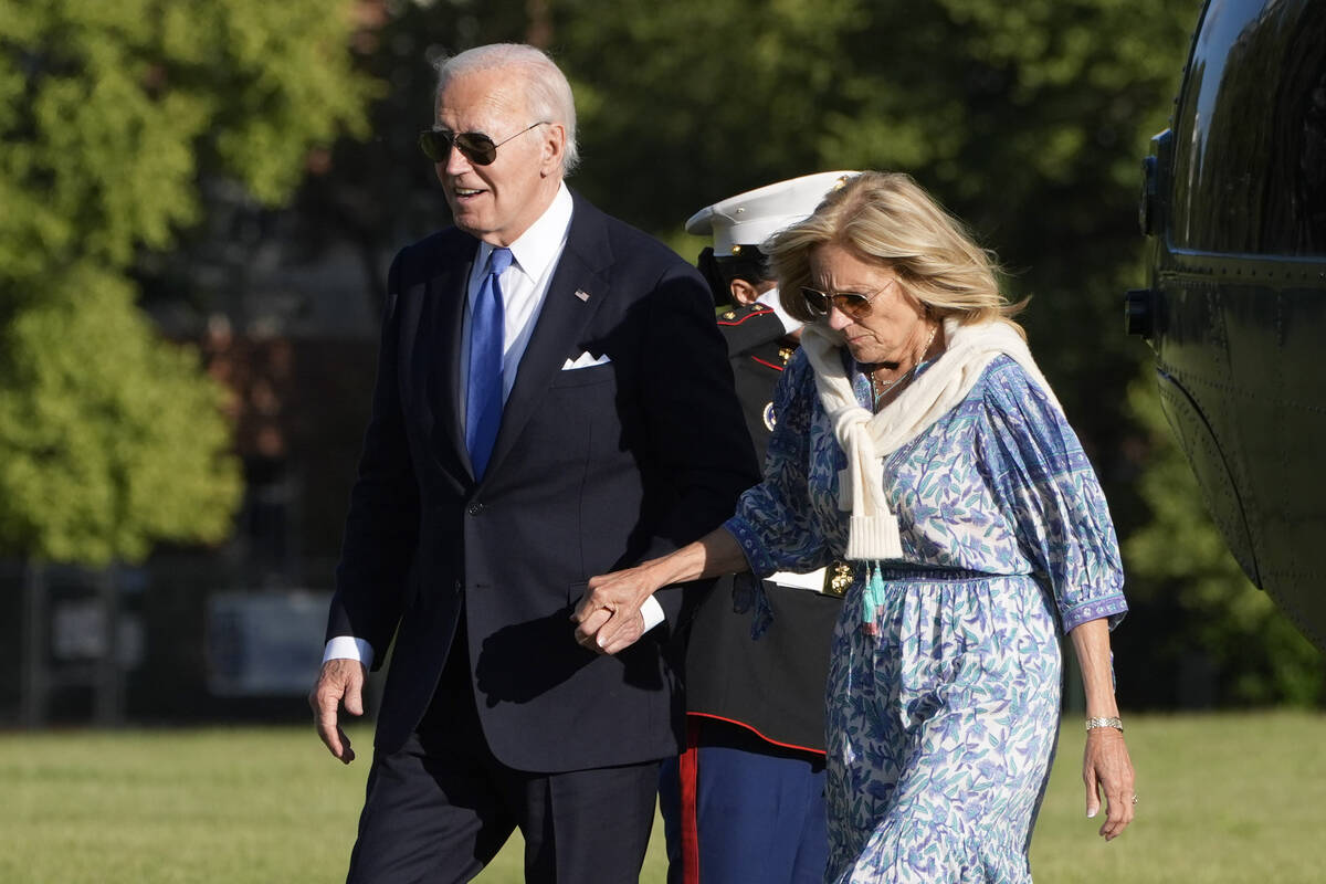 FILE - President Joe Biden, left, and first lady Jill Biden hold hands as they arrive at Fort L ...