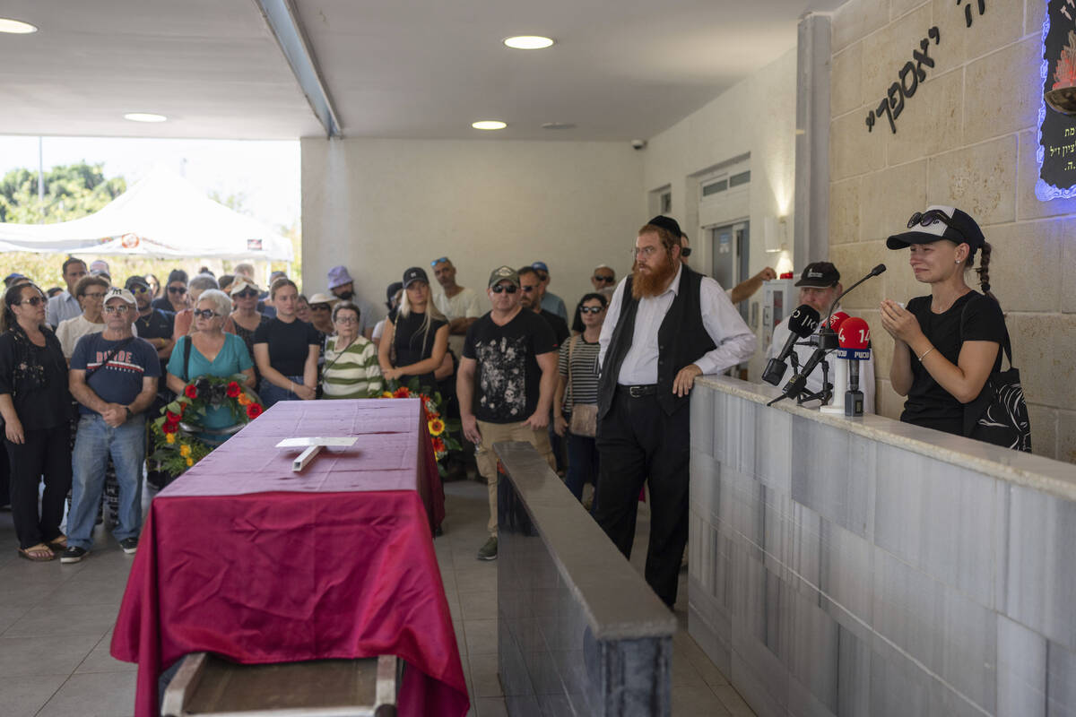 Family and friends of Yevgeny Ferde attend his funeral at a cemetery in Rishon Lezion, Israel, ...