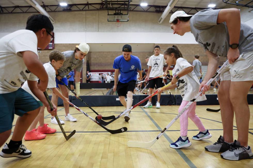 Local kids face off during a street hockey camp at the Veterans Memorial Community Center on Tu ...