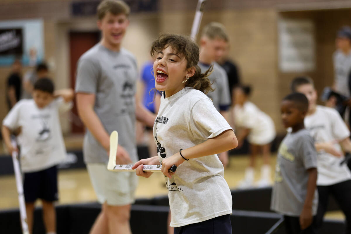 A local player celebrates after scoring a goal during a a street hockey camp at the Veterans Me ...