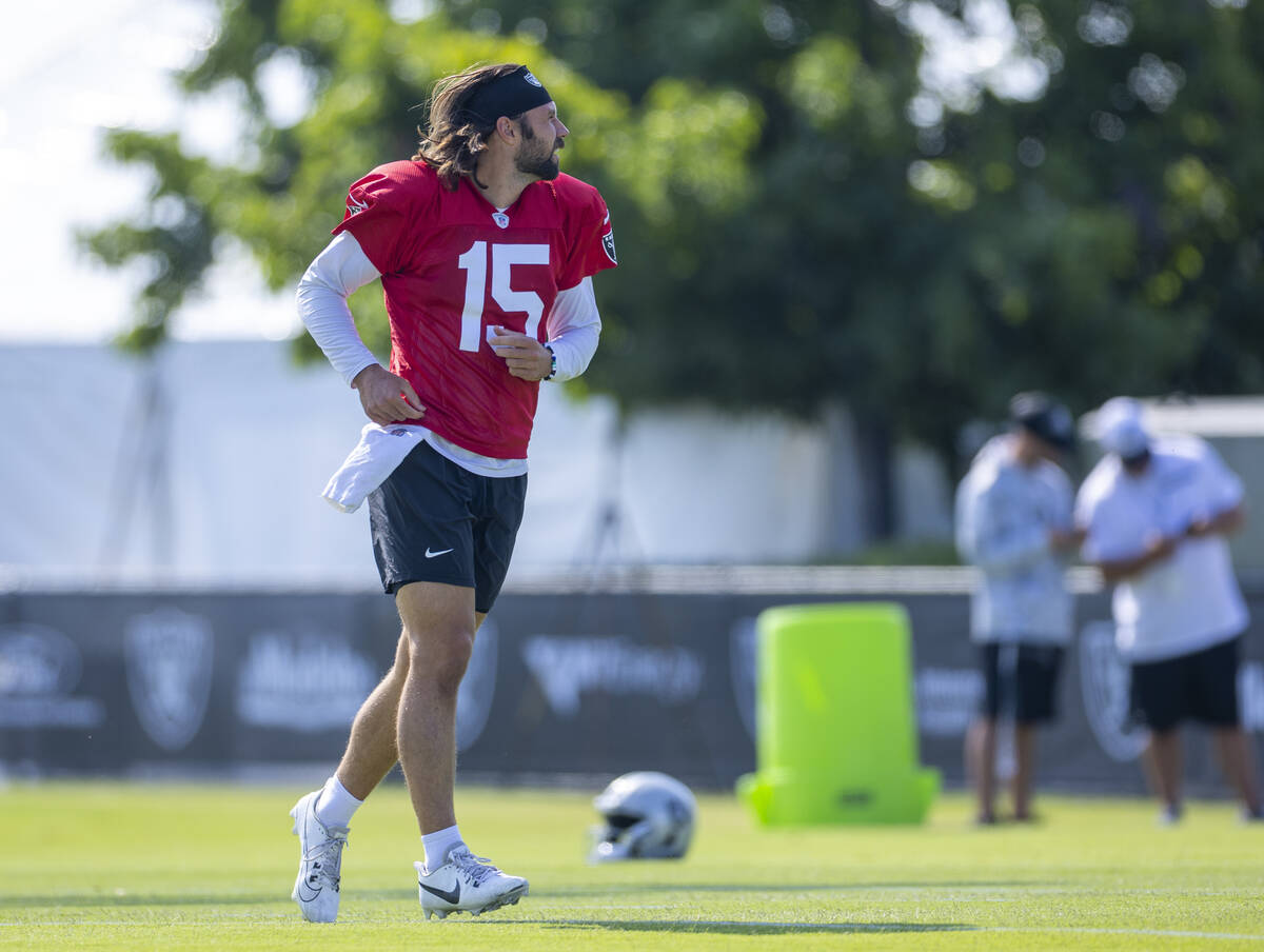 Raiders quarterback Gardner Minshew (15) runs across the field during the first day of training ...