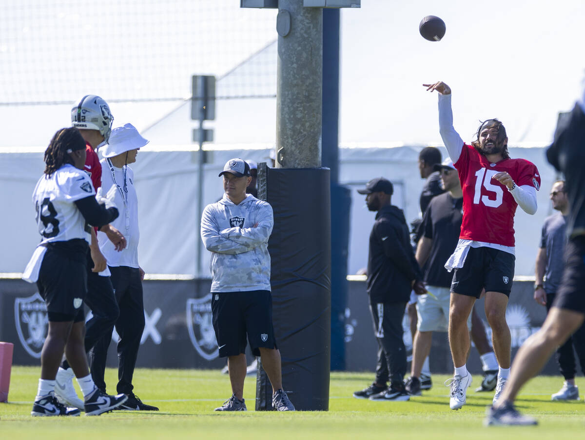 Raiders quarterback Gardner Minshew (15) tosses a ball during the first day of training camp at ...