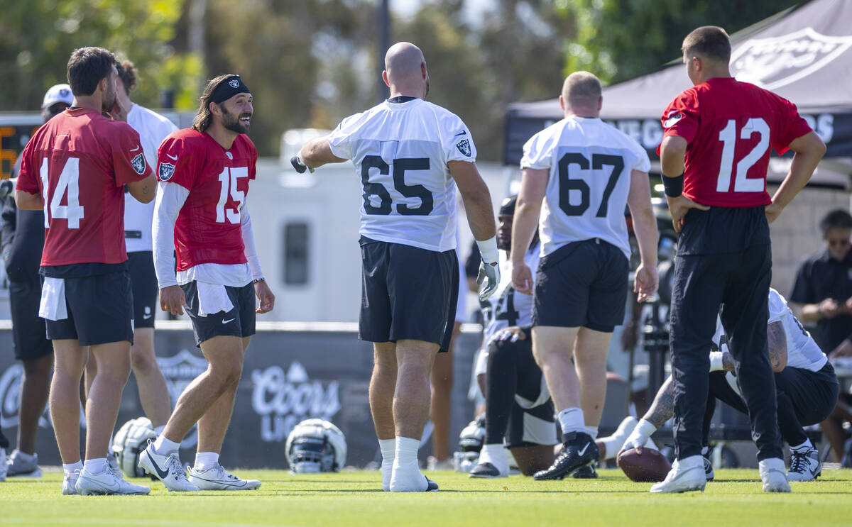 Raiders quarterback Gardner Minshew (15) shares a laugh with guard Cody Whitehair (65) during t ...