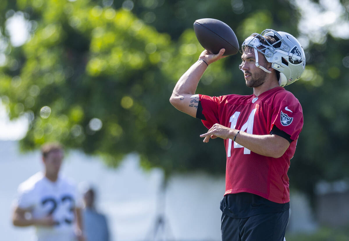 Raiders quarterback Carter Bradley (14) tosses the ball to a teammate during the first day of t ...