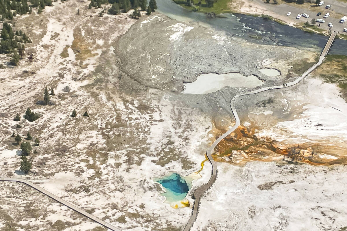 In this aerial photo released by the National Park Service, shows the damaged Biscuit Basin boa ...