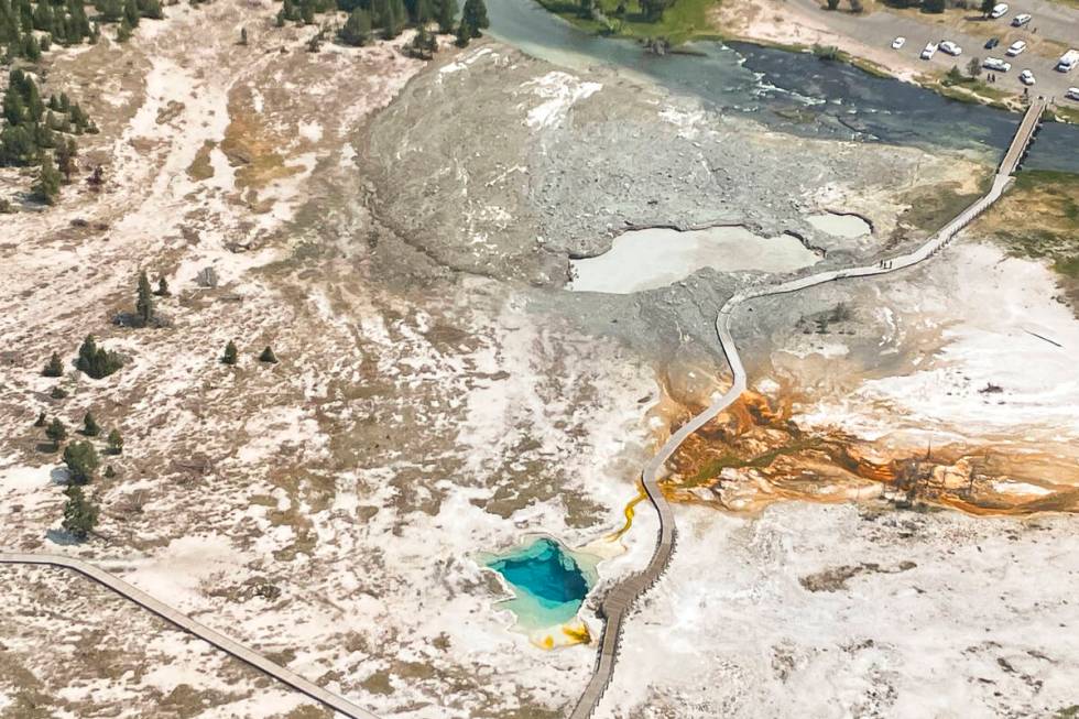 In this aerial photo released by the National Park Service, shows the damaged Biscuit Basin boa ...