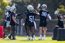 Raiders defensive end Maxx Crosby (98) greets defensive end Malcolm Koonce (51) during the firs ...