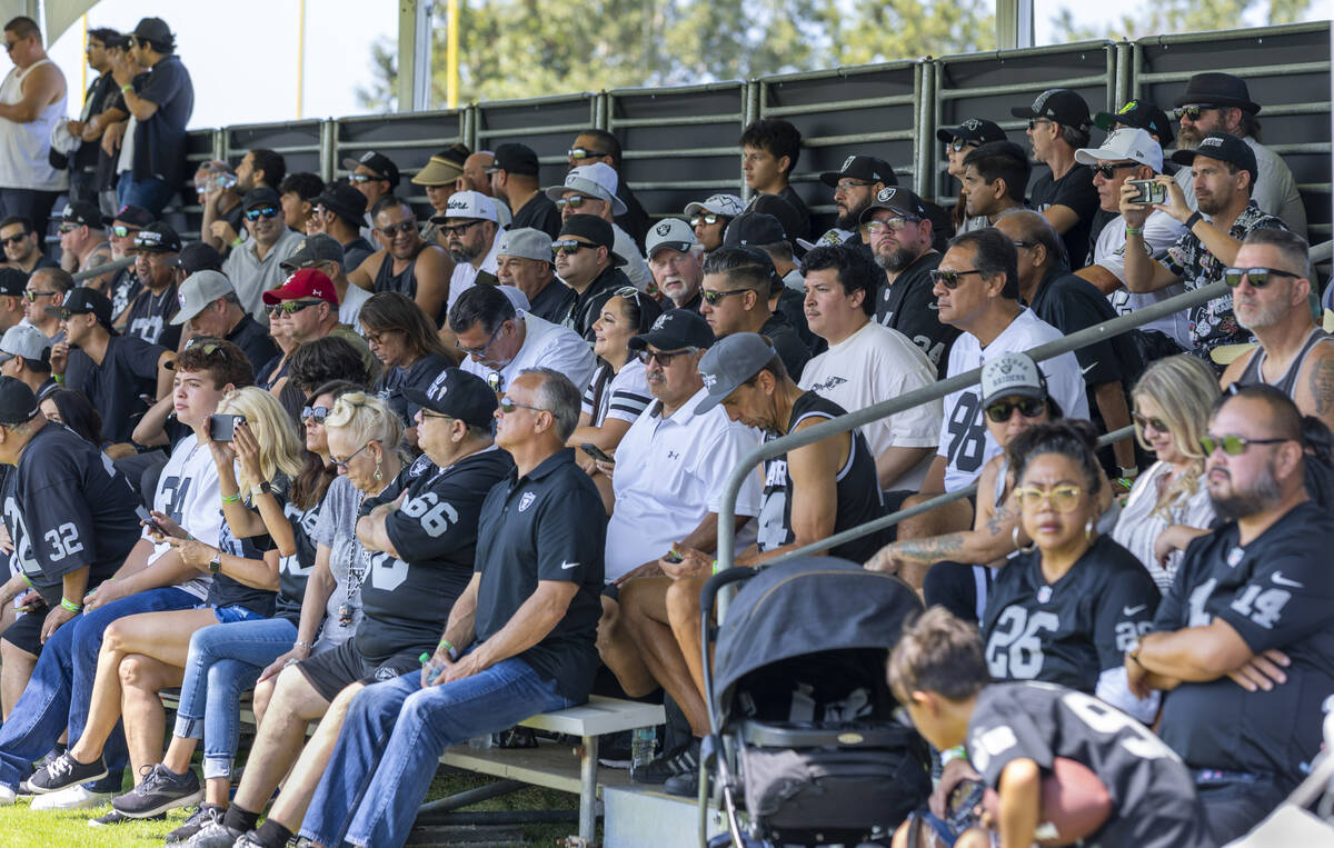Raiders fans watch players practice during the first day of training camp at the Jack Hammett S ...