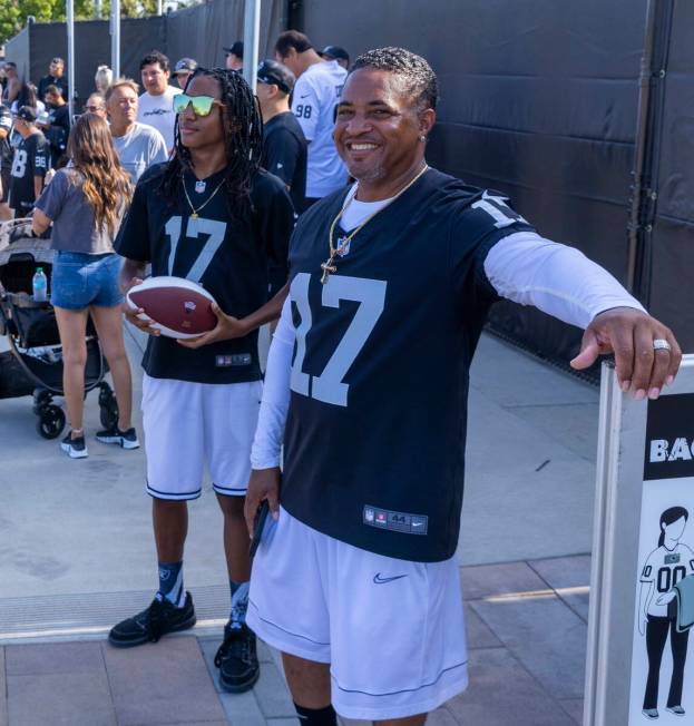 Raiders fans Laron Evans, 12, and his father Ronald wait to enter for the first day of training ...