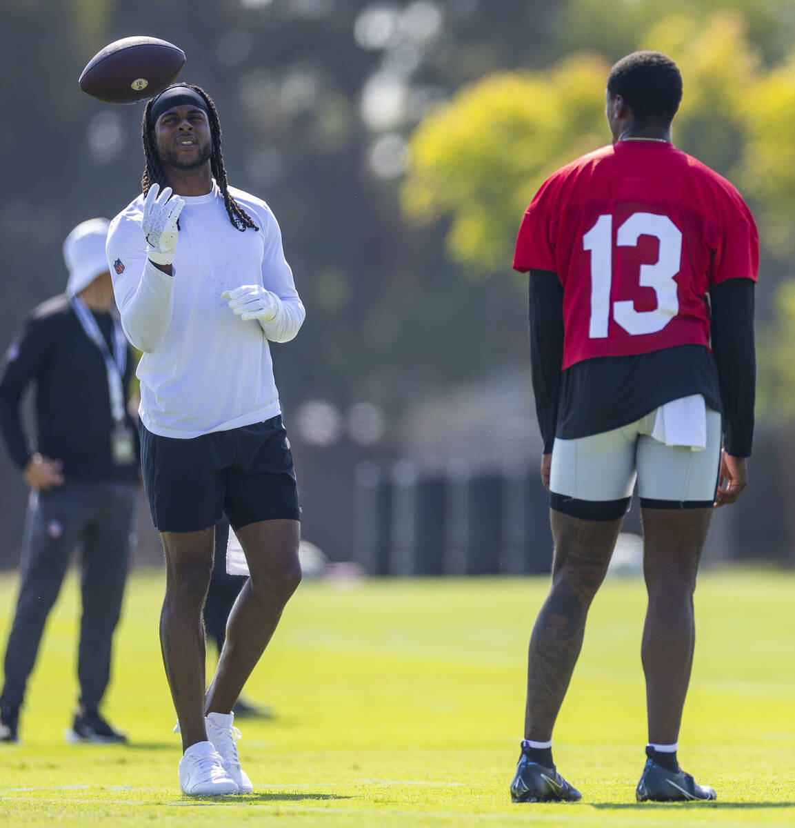 Raiders wide receiver Davante Adams (17) toss up a ball as quarterback Anthony Brown Jr. (13) l ...