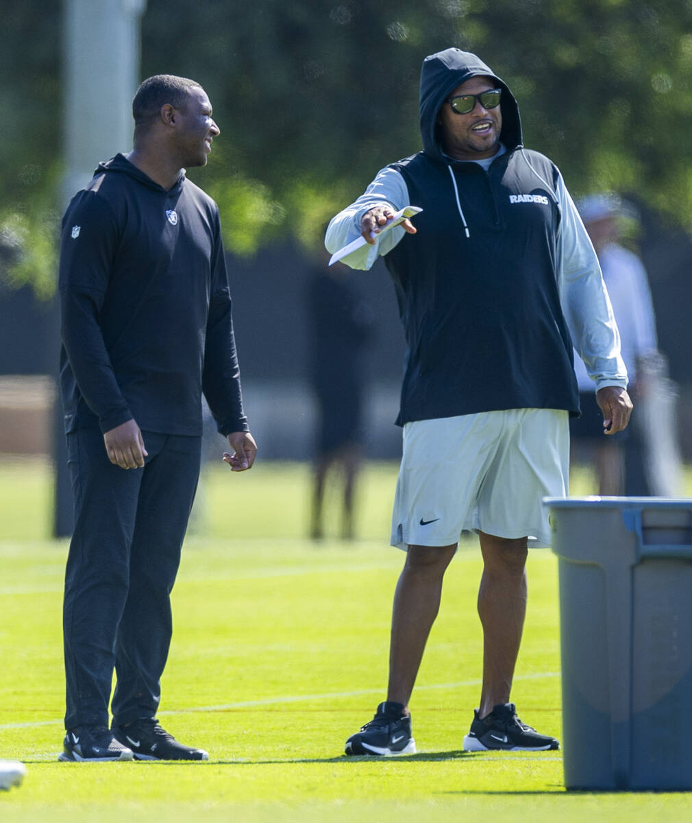 Raiders head coach Antonio Pierce talks with a member of the staff during the second day of Rai ...