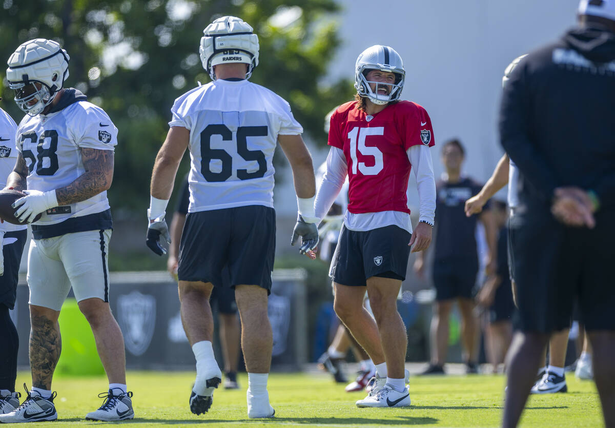 Raiders quarterback Gardner Minshew (15) shares a laugh with teammates during the second day of ...