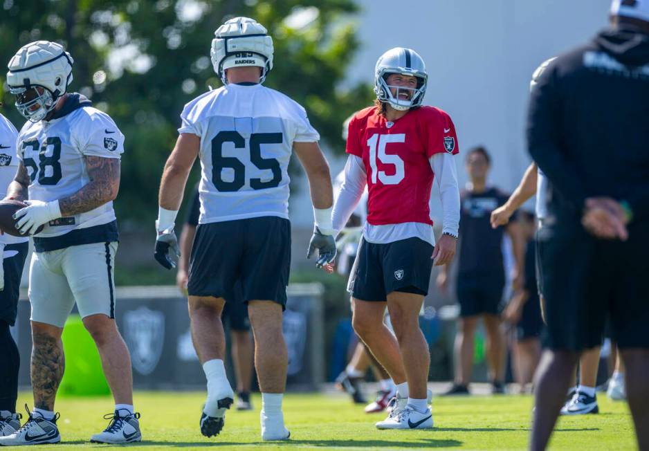 Raiders quarterback Gardner Minshew (15) shares a laugh with teammates during the second day of ...