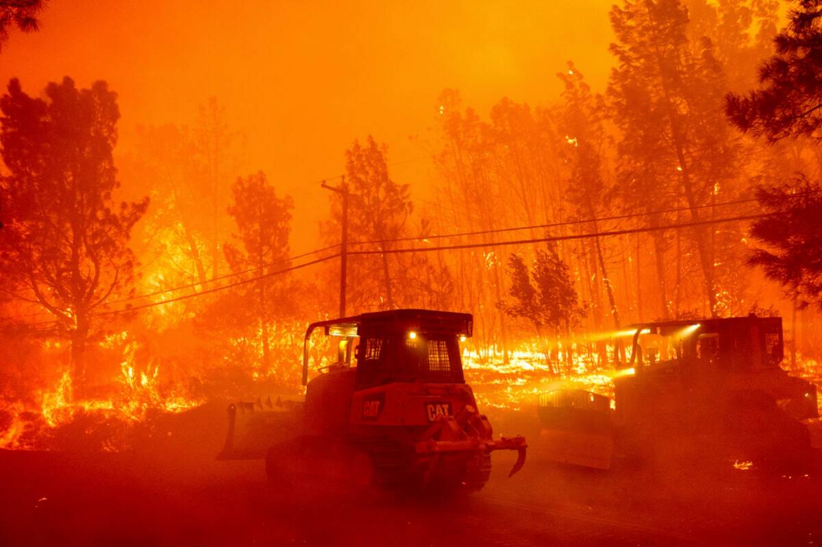 A hillside burns as the Park Fire tears though the Cohasset community in Butte County, Calif., ...