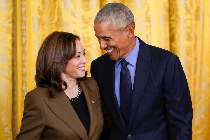 Former President Barack Obama talks with Vice President Kamala Harris during an event about the ...