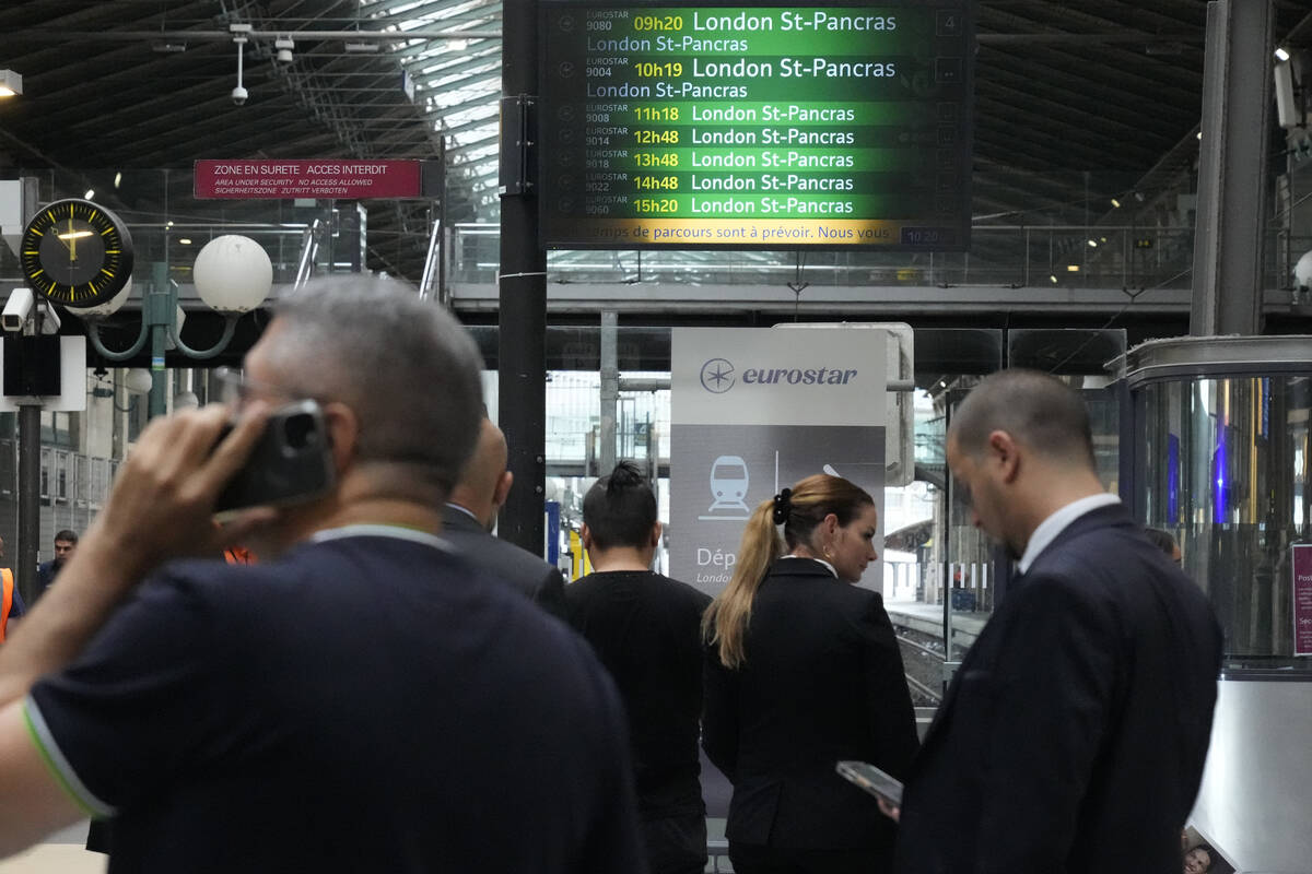 Travelers wait at the Eurostar platform inside the Gare du Nord train station at the 2024 Summe ...