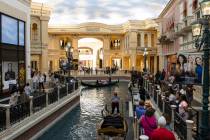 Tourists take a gondola ride in the Grand Canal at the Venetian hotel-casino photographed, on T ...