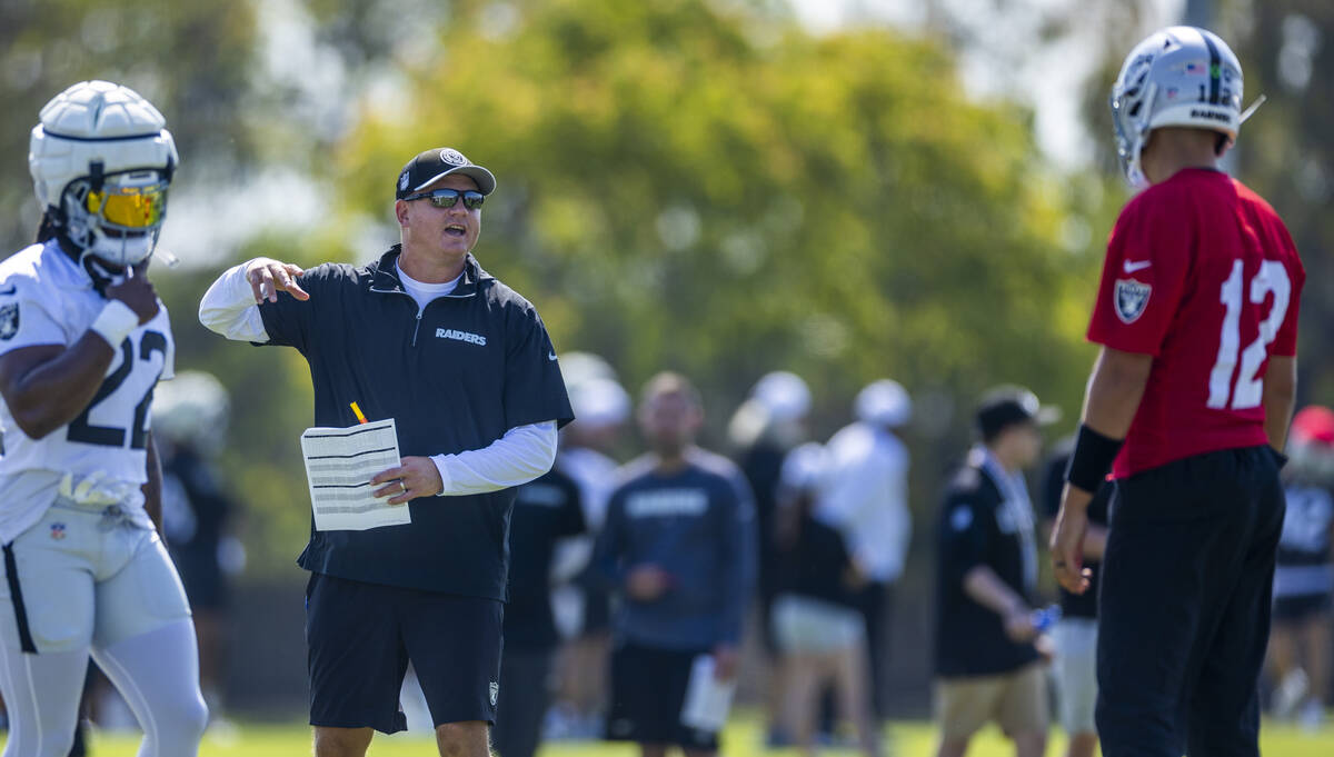 Raiders offensive coordinator Luke Getsy talks with quarterback Aidan O'Connell (12) after a pl ...