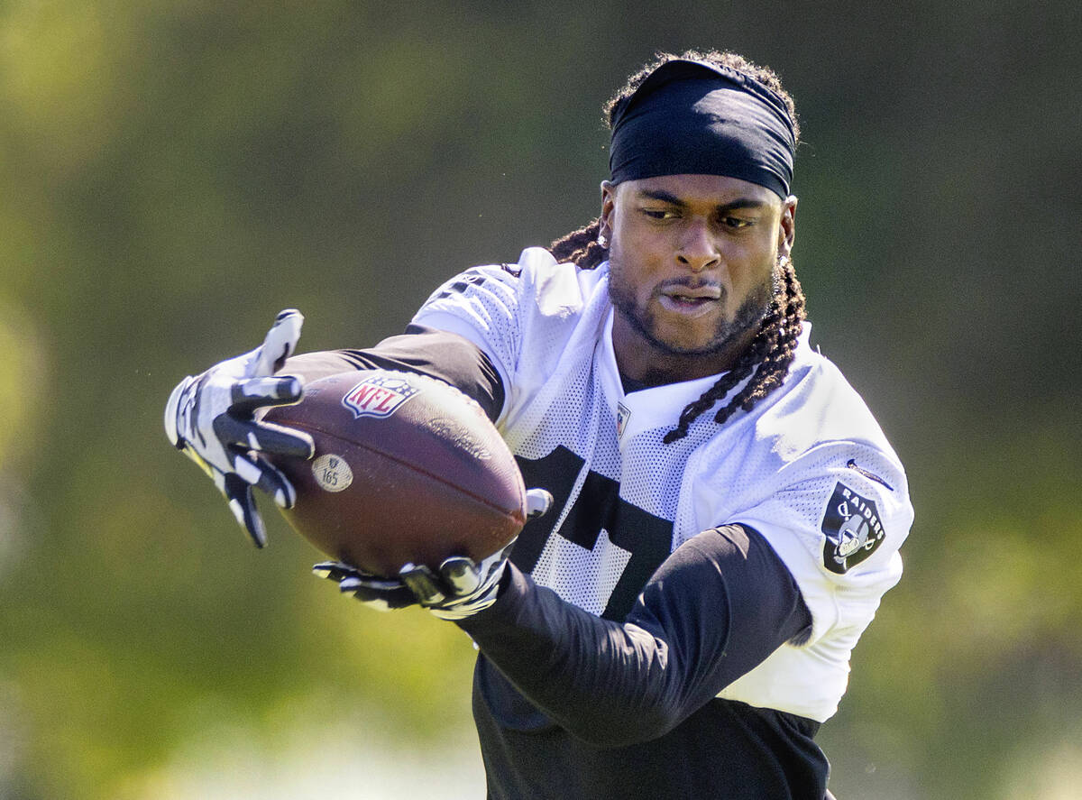 Raiders wide receiver Davante Adams (17) looks in a pass during the third day of Raiders traini ...