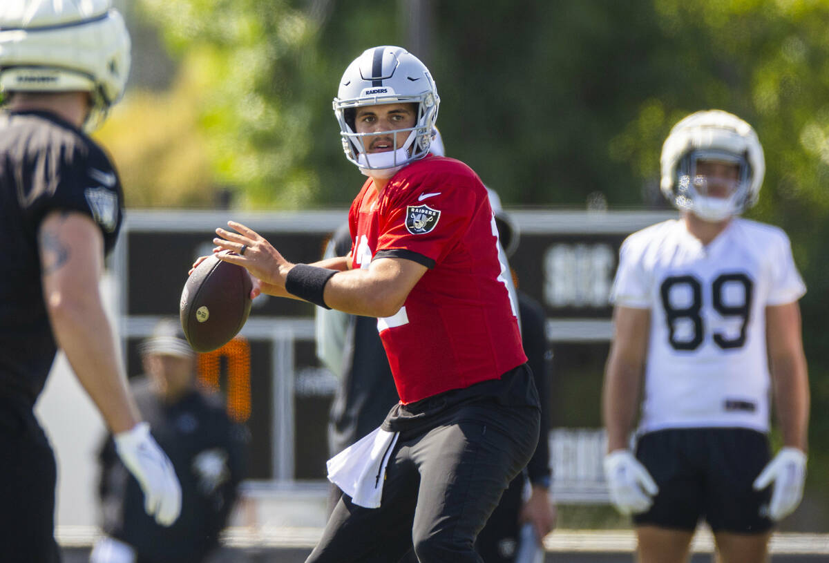 Raiders quarterback Aidan O'Connell (12) looks for a receiver during the third day of Raiders t ...