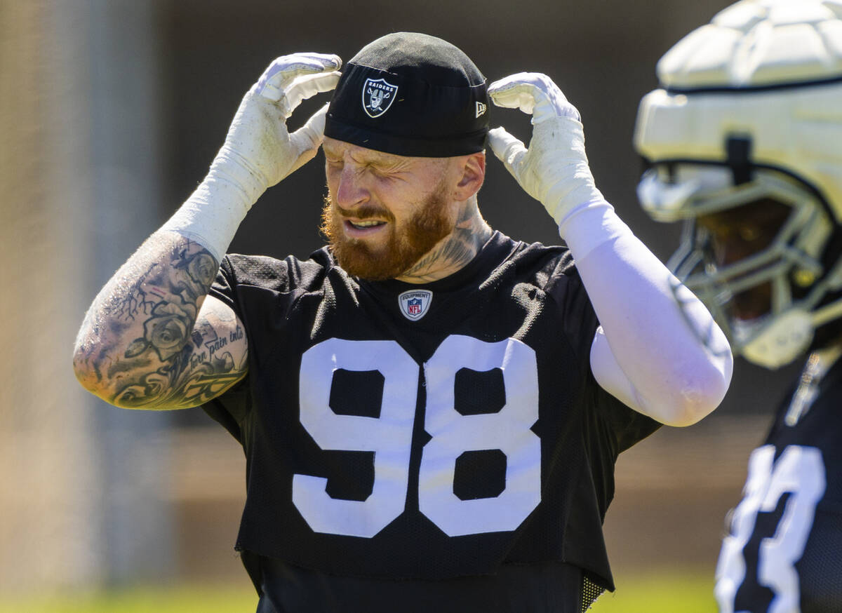 Raiders defensive end Maxx Crosby (98) adjust his cap during the third day of Raiders training ...